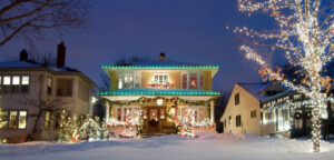 House with seasonal lighting decorated with festive items and bright led strands in the snow