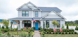 House with new roof showing American flag on the front porch