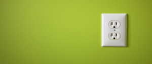 Green wall with white standard electrical socket
