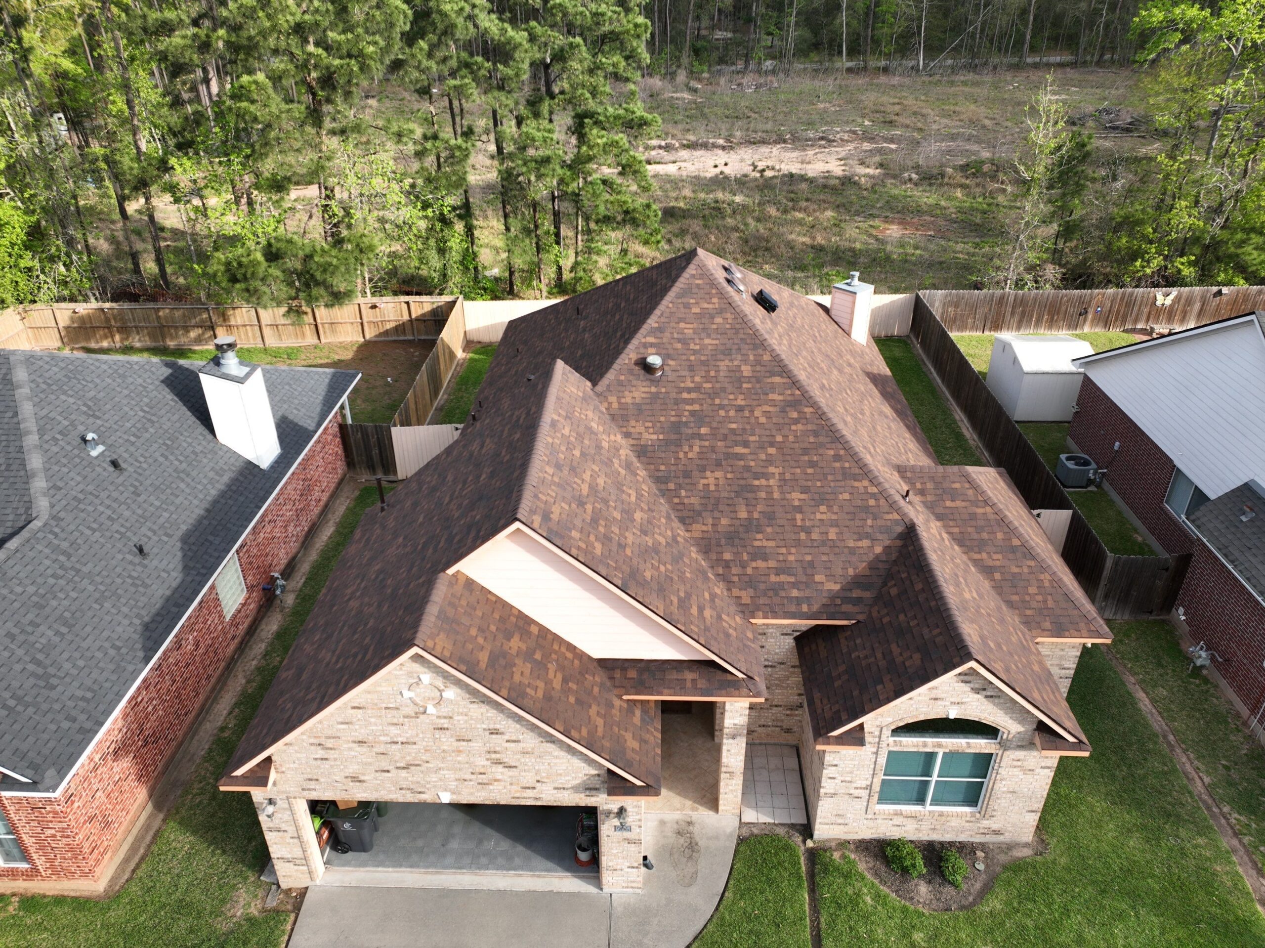 Completed Owens Corning Duration STORM Class 4 impact resistant roof replacement with 30-watt solar attic fan on residential home in Conroe Texas by Roof Concepts Construction